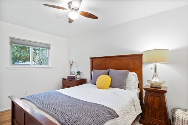 bedroom with light wood-style flooring and a ceiling fan