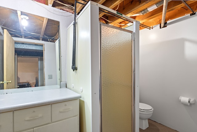 full bath featuring toilet, vanity, and a shower with shower door