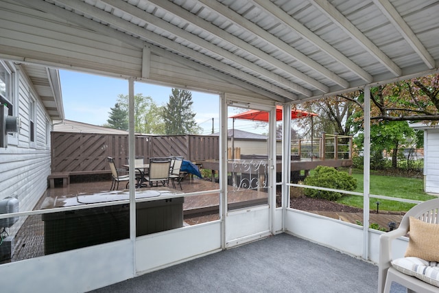 unfurnished sunroom with plenty of natural light and outdoor dining space