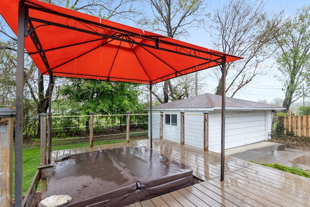 wooden terrace featuring an outdoor structure, fence, a garage, and a gazebo