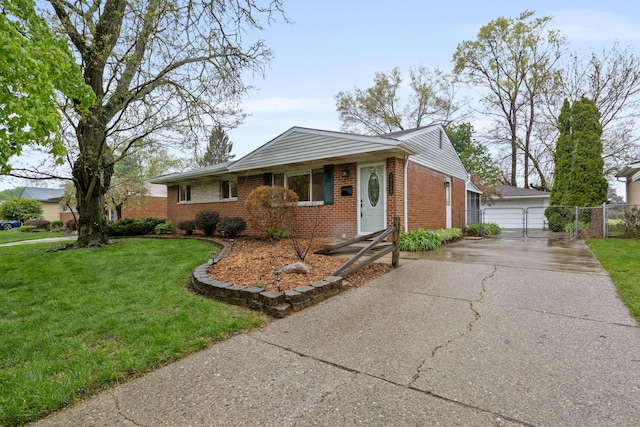 view of front of home featuring a garage, brick siding, fence, and a front yard
