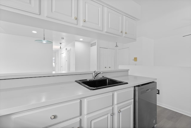 kitchen featuring a sink, stainless steel dishwasher, light countertops, and white cabinets