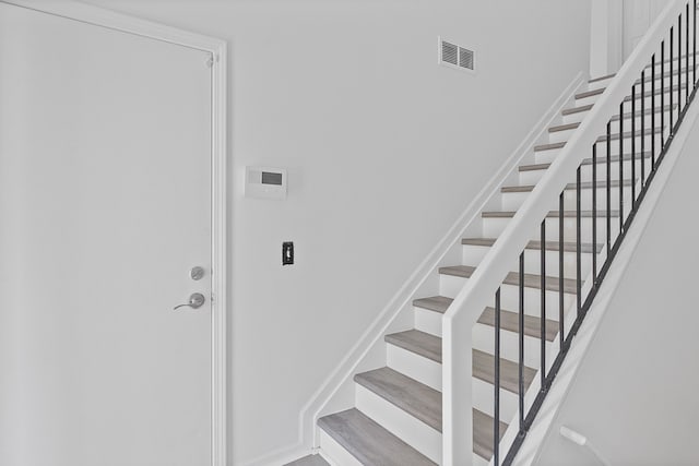 stairway featuring visible vents