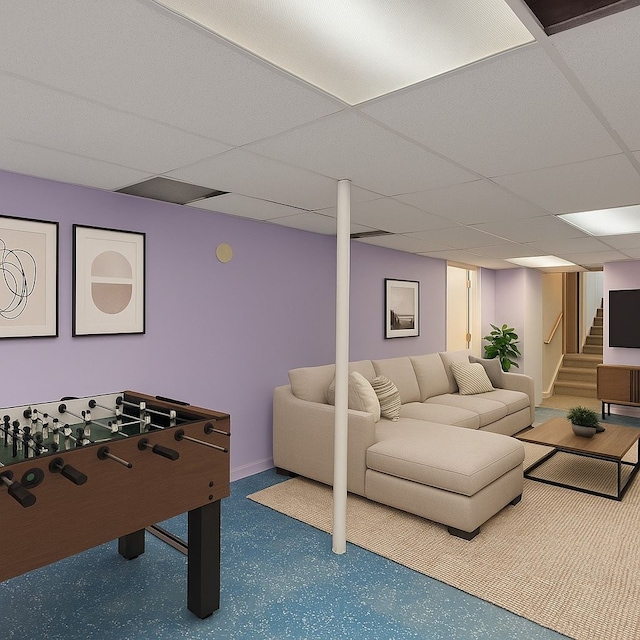 game room with baseboards and a paneled ceiling