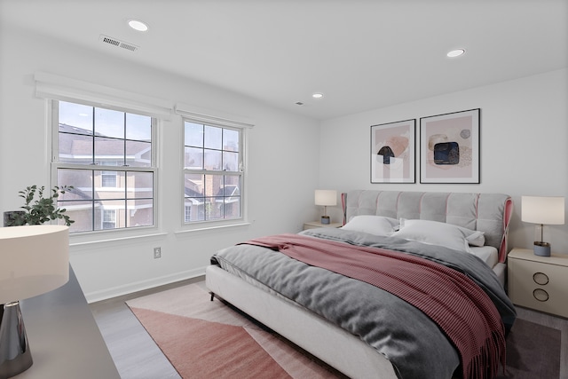 bedroom with recessed lighting, baseboards, visible vents, and wood finished floors