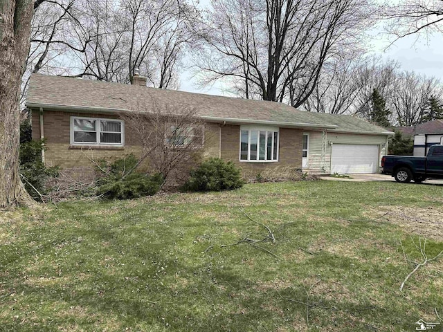 single story home with a chimney, brick siding, an attached garage, concrete driveway, and a front yard
