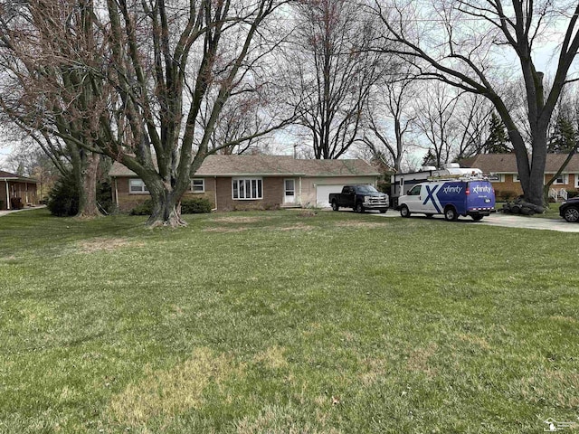 view of front of property with driveway, a garage, and a front yard