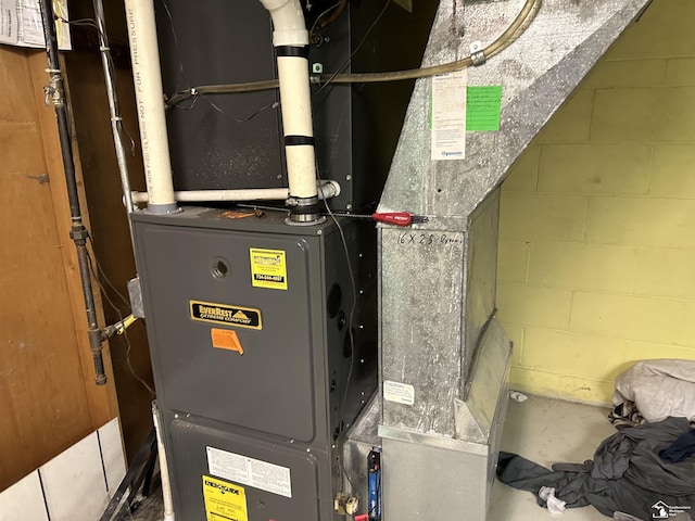 utility room featuring heating unit