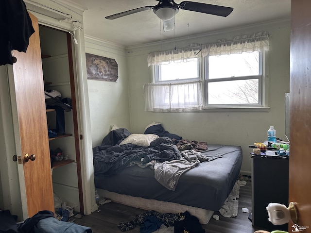 bedroom with ornamental molding, ceiling fan, and wood finished floors