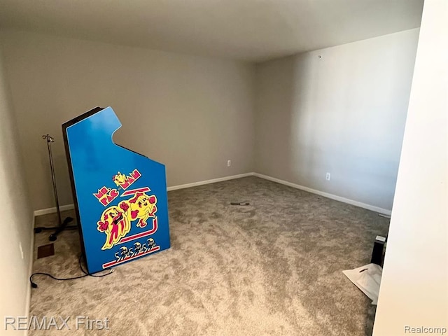 unfurnished room with carpet and baseboards