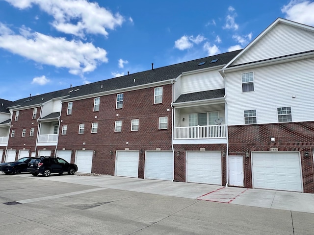 view of property with an attached garage and driveway