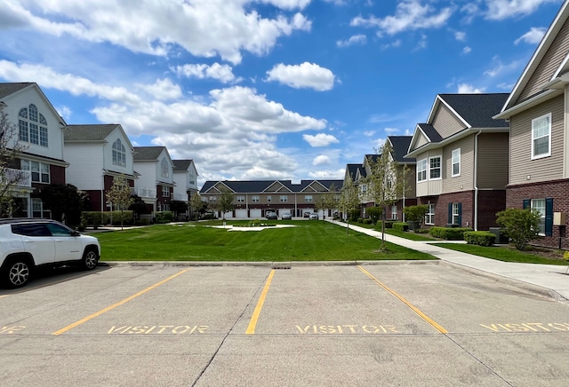 uncovered parking lot featuring a residential view