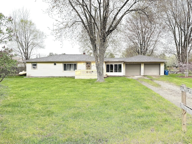 ranch-style house featuring a front lawn, driveway, and a garage