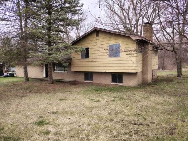 12416 Nichols Rd, Montrose, MI 48457 - view of side of home featuring a chimney and a lawn