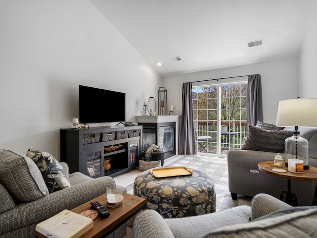 living room featuring a multi sided fireplace, visible vents, lofted ceiling, and recessed lighting