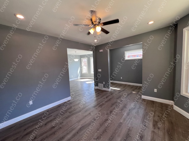 empty room featuring wood finished floors, baseboards, ceiling fan, and recessed lighting