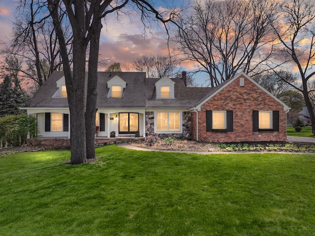 22641 N Nottingham Dr, Beverly Hills, MI 48025 - cape cod-style house featuring a shingled roof, brick siding, and a lawn