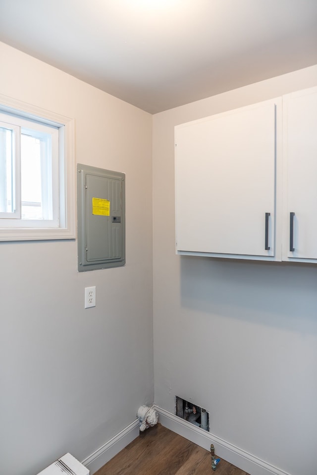 9114 Island Dr, Clay, MI 48001 - washroom featuring electric panel, cabinet space, baseboards, dark wood-style floors, and hookup for a washing machine