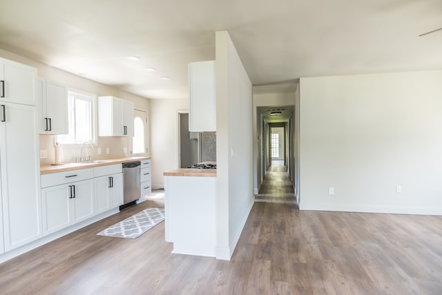 9114 Island Dr, Clay, MI 48001 - kitchen with dishwasher, a sink, wood finished floors, baseboards, and white cabinetry