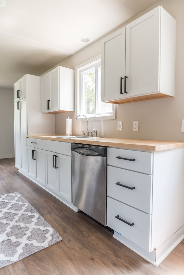 9114 Island Dr, Clay, MI 48001 - kitchen with stainless steel dishwasher, dark wood-type flooring, a sink, white cabinets, and light countertops