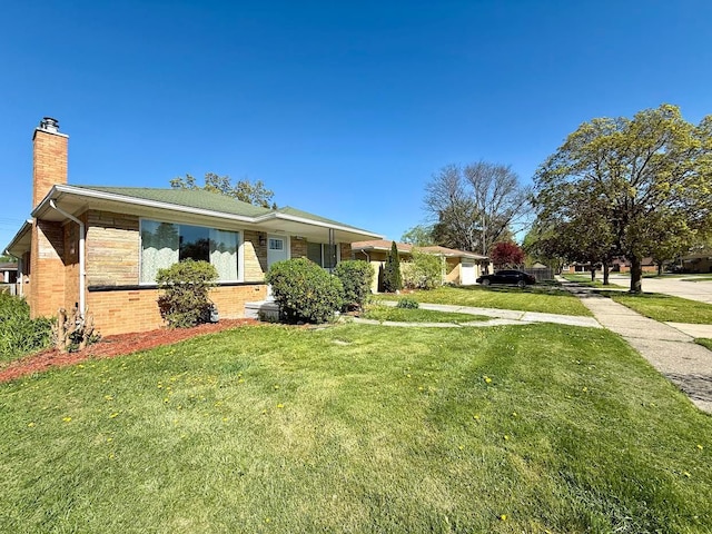 view of home's exterior with brick siding, a chimney, and a lawn