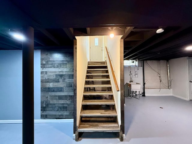 unfinished basement with a sink and stairs