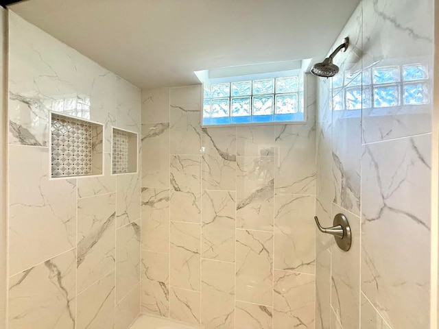full bathroom featuring tiled shower