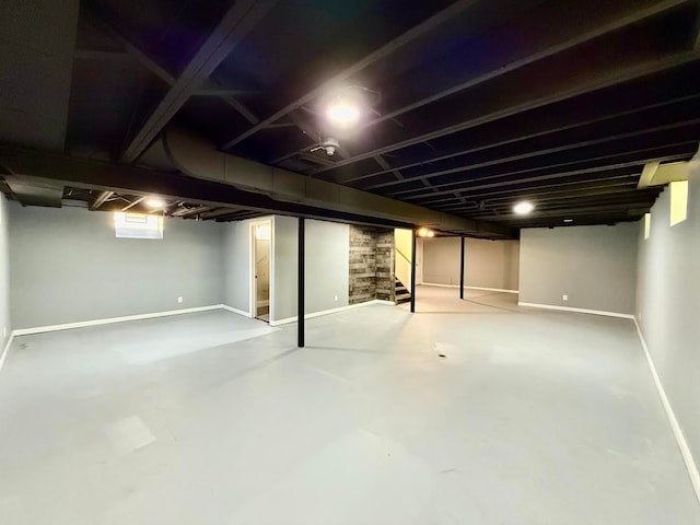 finished basement featuring stairway and baseboards
