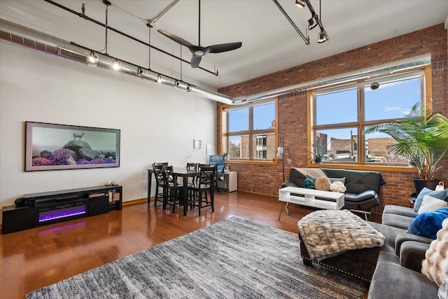 444 W Willis St Unit 204, Detroit, MI 48201 - living room with brick wall, a ceiling fan, wood finished floors, and rail lighting