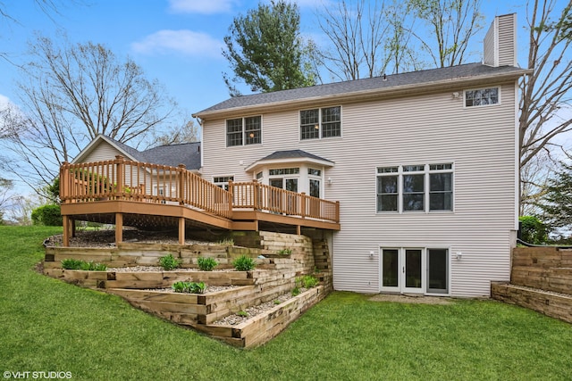 rear view of house featuring a lawn, a chimney, a wooden deck, and french doors