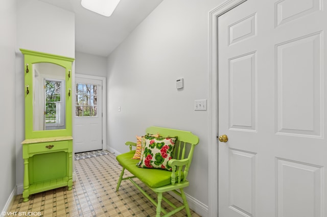 doorway to outside featuring baseboards and tile patterned floors