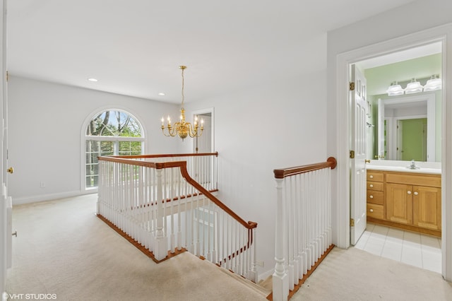 staircase with carpet floors, baseboards, a notable chandelier, and recessed lighting