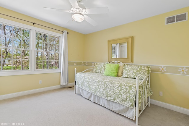 bedroom featuring carpet, visible vents, baseboards, and ceiling fan