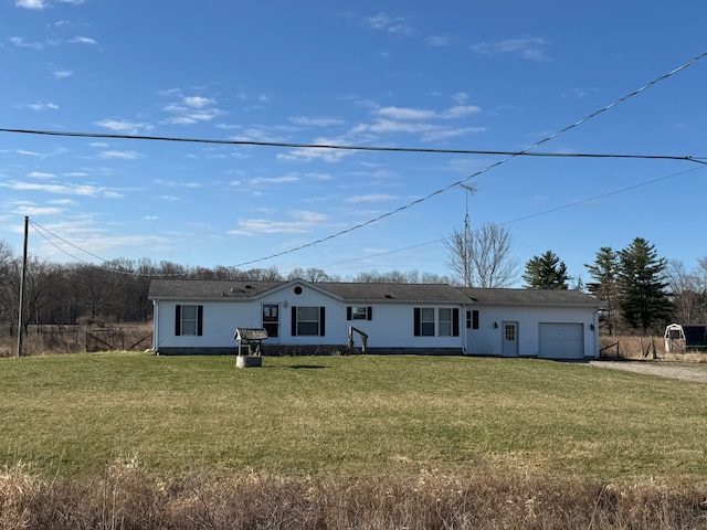 ranch-style home with a garage and a front lawn