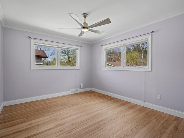 spare room featuring baseboards, light wood-style floors, and ceiling fan