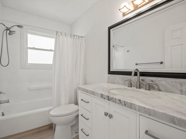 bathroom featuring vanity, toilet, wood finished floors, and shower / bath combination with curtain