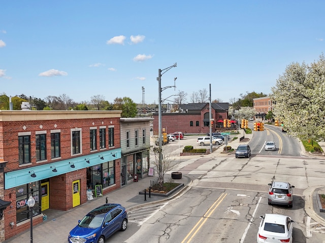 view of road with curbs, sidewalks, and street lights