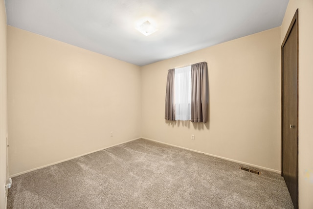 unfurnished bedroom with carpet, visible vents, baseboards, and a closet