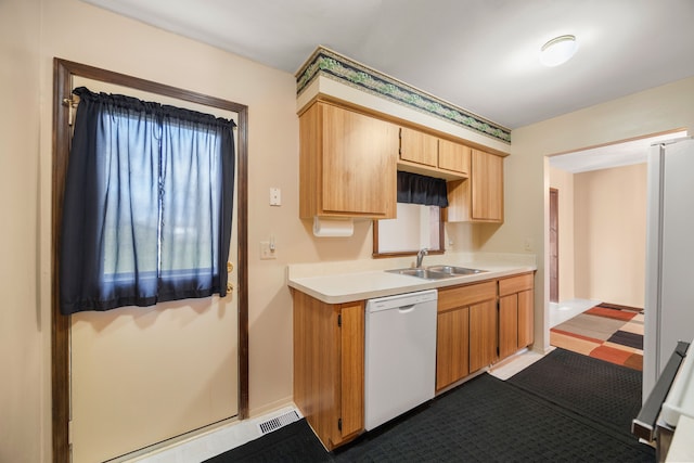 kitchen featuring light countertops, visible vents, a sink, and white appliances