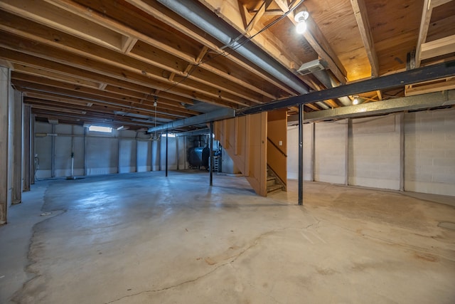 unfinished basement with heating fuel and stairs
