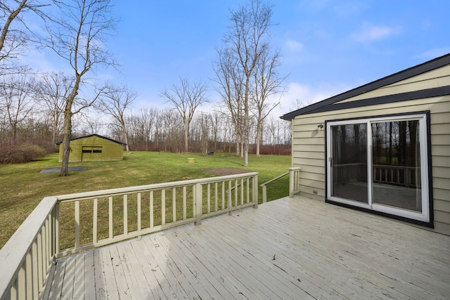 wooden deck with a lawn and an outdoor structure