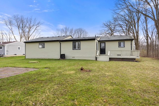 back of house featuring a lawn, a deck, roof with shingles, and crawl space