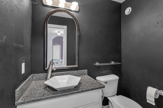 bathroom with toilet and vanity