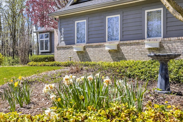 view of property exterior with brick siding