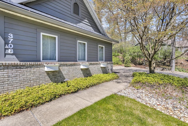 view of property exterior with brick siding