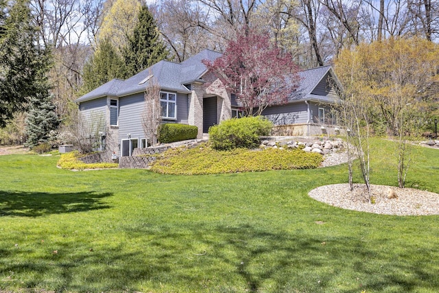 view of property exterior featuring an attached garage and a lawn