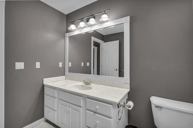 half bath featuring toilet and vanity