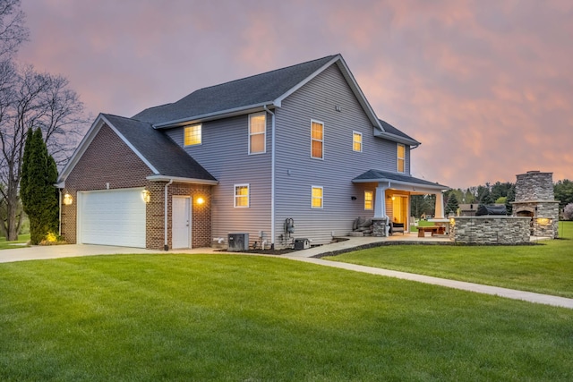 view of front facade featuring concrete driveway, a garage, cooling unit, and a front lawn