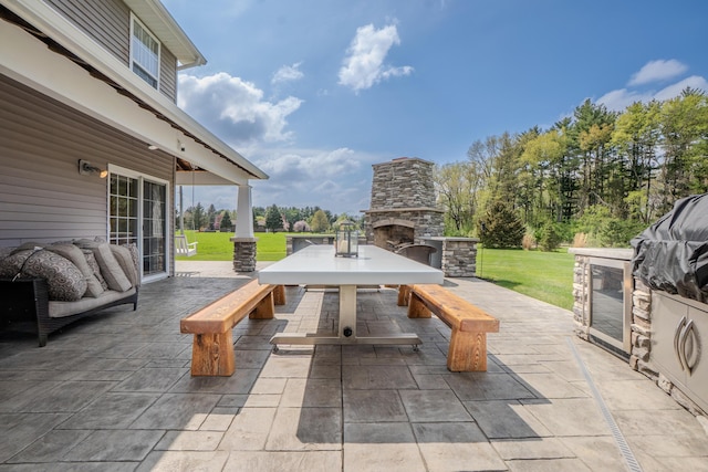 view of patio featuring an outdoor stone fireplace