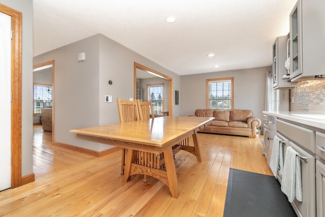 dining room with baseboards, a wealth of natural light, light wood-style floors, and recessed lighting